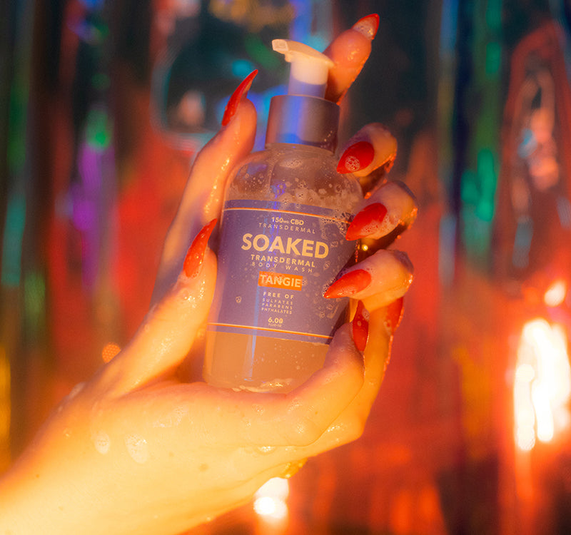 Soaked CBD Shower Gel being held by lathered hands in a holographic light set. V Cute.
